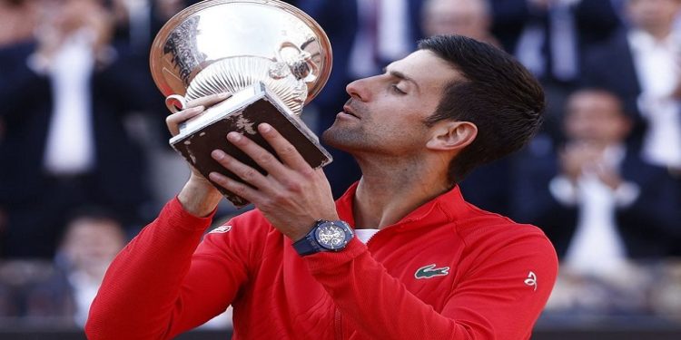 Novak Djokovic celebrates with the trophy after winning the final against Greece's Stefanos Tsitsipas.