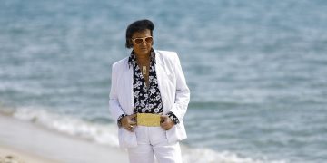 The 75th Cannes Film Festival - Cannes, France, May 25, 2022. Elvis Presley impersonator Eryl Prayer poses on the beach on the Croisette ahead of the screening of the film "Elvis" Out of Competition.