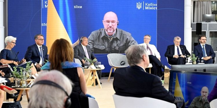Ukrainian Prime Minister Denys Shmyhal is visible on a screen during the finance ministers and central bank chiefs meeting of the Group of 7 (G7) most industrialised nations in Koenigswinter, near Bonn, Germany May 19, 2022.