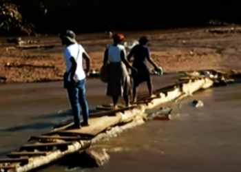 People walk across a bridge in KZN.