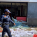 Police walk past a looted shop during the 2021 July unrest in Durban.