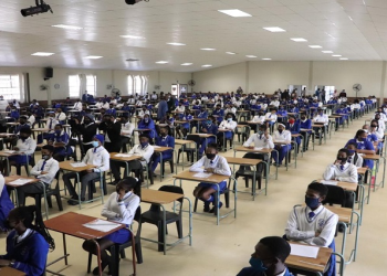 Matric learners are seen in a school hall writing their exams.