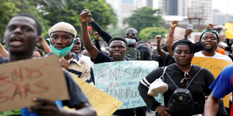 Nigerians take part in a protest against violence, extortion and harassment from Nigeria's Special Anti-Robbery Squad (SARS), in Lagos on October 11, 2020 [Reuters/Temilade Adelaja]