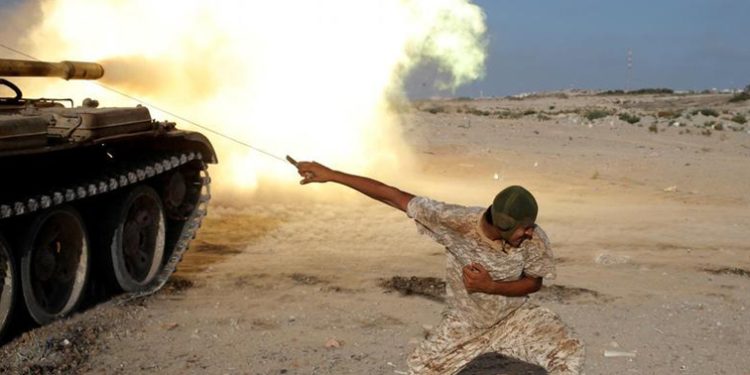 A fighter of Libyan forces allied with the UN-backed government fires a shell with Soviet made T-55 tank at Islamic State fighters in Sirte, Libya.