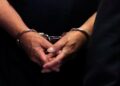 [File Image] A suspect's hands are shown in handcuffs.