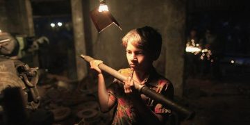 Shuvo, 7, works at a metal workshop which makes propellers for ships at a shipbuilding yard.