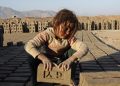 A  girl works at a brick-making factory.