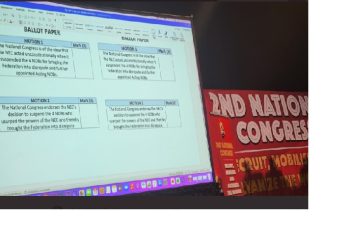 A presentation document on matters to be voted on is seen on the screen at the SAFTU congress.