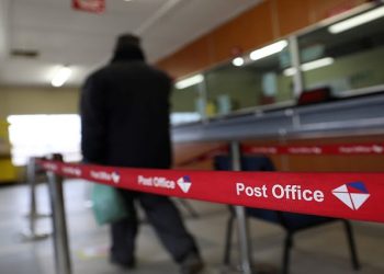 A customer arrives at the Post Office in Pimville, Soweto.