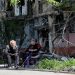 [File Image] Local residents sit in a courtyard near a block of flats heavily damaged during the Ukraine-Russia conflict, in the southern port city of Mariupol, Ukraine May 20, 2022.
