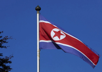 North Korean flag flies on a mast at the Permanent Mission of North Korea in Geneva October 2, 2014.