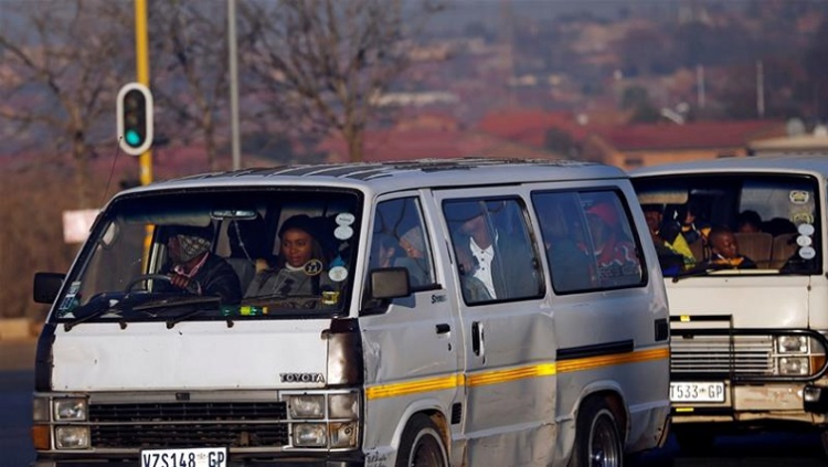 Passengers in a minibus taxi on a South African road.