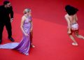 The 75th Cannes Film Festival - Screening of the film "Three Thousand Years of Longing" Out of Competition - Red Carpet Arrivals - Cannes, France, May 20, 2022. Rose Bertram poses as a woman runs while protesting.