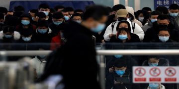 People wearing face masks commute in a subway station during morning rush hour, following the coronavirus disease ( COVID-19) outbreak, in Beijing, China January 20, 2021.