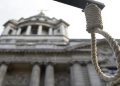 A replica hangman's noose is seen during a protest.