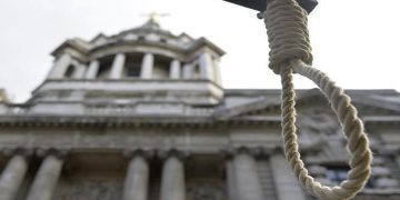 A replica hangman's noose is seen during a protest.