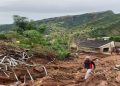 A man walks past damage caused by the KwaZulu-Natal floods in April 2022