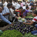 Customers buy vegetables at a market in Ahmedabad, India,