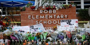 Flowers, candles and signs are left at a memorial for victims of the Robb Elementary school shooting, three days after a gunman killed nineteen children and two teachers, in Uvalde, Texas, U.S. May 27, 2022.