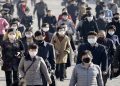 People wearing protective face masks commute amid concerns over the new coronavirus disease (COVID-19) in Pyongyang, North Korea March 30, 2020.
