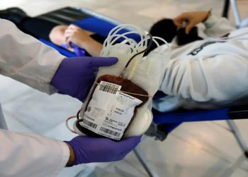 A blood bag is pictured as a patient donates blood.
