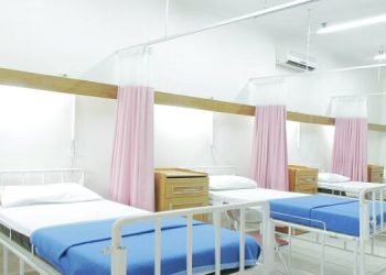 A hospital ward with empty beds.