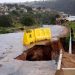 Water from heavy rains runs along a road, which was damaged during previous flooding, in kwaNdengezi near Durban, South Africa, May 22, 2022.
