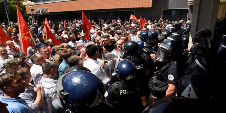 Riot police line up to secure the parliament building as hundreds of Kosovo War veterans protest, asking for a pension rise, in Pristina, Kosovo June 6, 2022.