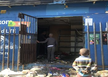 File: Children stand at the door of a looted shop in Alexandra, Johannesburg.