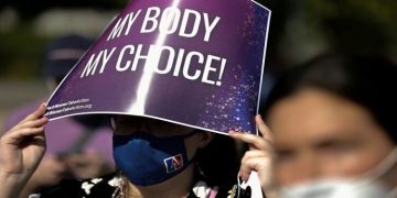 A protester holds a sign during nationwide demonstrations following the leaked Supreme Court opinion suggesting the possibility of overturning the Roe v. Wade abortion rights decision.