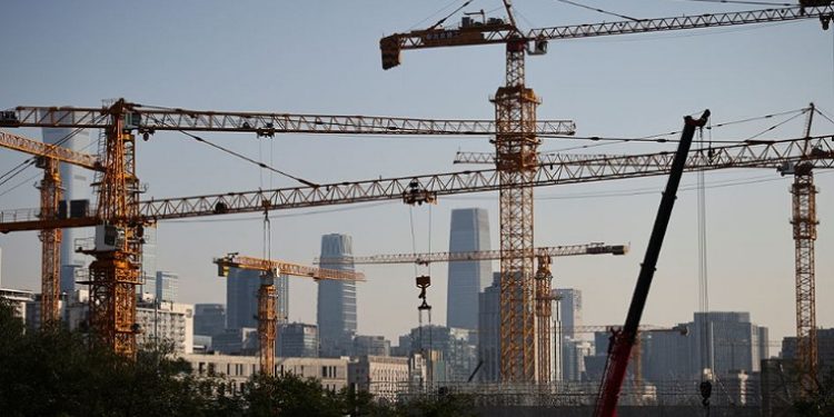 A view shows cranes in front of the skyline of the Central Business District (CBD) in Beijing, China, October 18, 2021.