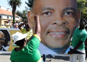 A supporter gestures in front of a picture of Ace Magashule at the Bloemfontein high court in the Free State province, South Africa, in November 2020.