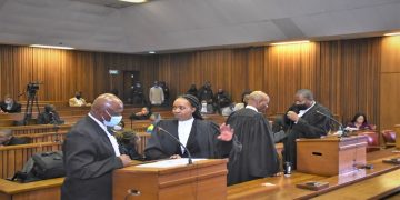 Legal representatives conversing during the Senzo Meyiwa murder trial.