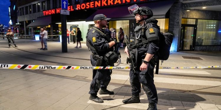 Security forces stand at the site where several people were injured during a shooting outside the London pub in central Oslo, Norway June 25, 2022.