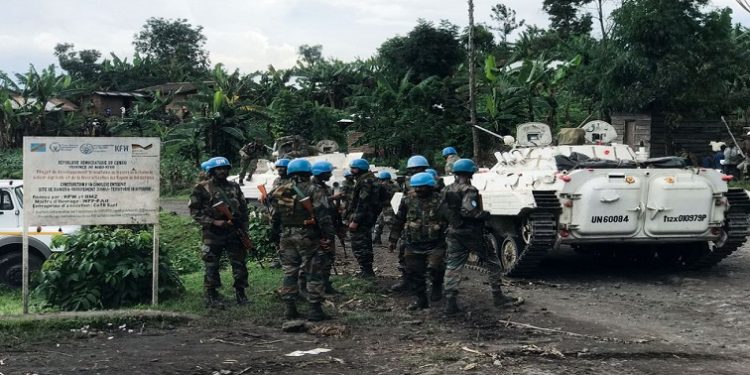 United Nations Organization Stabilization Mission in the Democratic Republic of the Congo (MONUSCO) peacekeepers gather as they patrol areas affected by the recent attacks by M23 rebels fighters near Rangira in North Kivu in the east of the Democratic Republic of Congo, March 29, 2022.