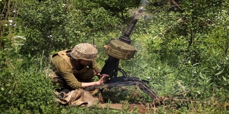 A Ukrainian service member shoots from an automatic grenade launcher at a position on the front line, amid Russia's attack on Ukraine, near Bakhmut, Donbas region, Ukraine June 5, 2022.