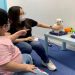 Autism tutor Sarah Ng uses robots to teach a 5-year-old child with special needs to introduce herself, in Hong Kong, China April 17, 2021. Picture taken April 17, 2021.