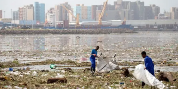 Cleaning crew picks up plastics from debris in the harbour after massive flooding in Durban, South Africa. REUTERS/Rogan Ward