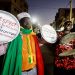 Ibrahima Soumare, 47, a supporter of Senegal's main opposition coalition Yewwi Askan Wi holds signs glued on pot lids during a protest over the disqualification of their national list for the July 31 legislative election in Dakar, Senegal, June 22, 2022.