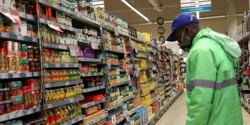A shopper wearing a face mask looks at grocery items, at Mall of the South, in Johannesburg, June 17, 2020.