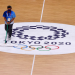 A staff member cleans the floor over the Tokyo 2020 Olympics logo, Yoyogi National Stadium - Tokyo, Japan - August 4, 2021.
