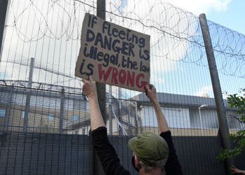 Demonstrators protest outside of Brook House Immigration Removal Centre against a planned deportation of asylum seekers from Britain to Rwanda, at Gatwick Airport near Crawley, Britain, June 12, 2022. REUTERS/Toby Melville.