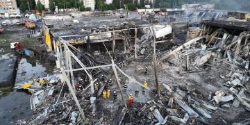 Rescuers work at a site of a shopping mall hit by a Russian missile strike, as Russia's attack on Ukraine continues, in Kremenchuk, in Poltava region, Ukraine, in this handout picture released June 28, 2022.