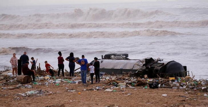 A petrol tanker trailer lies on the beach after heavy rains caused flooding, in Durban, South Africa, April 12, 2022.