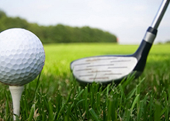A golf ball and club seen at a tee off