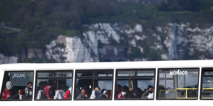 Migrants sit onboard a transport bus in Dover Harbour after being rescued while crossing the English Channel in Dover, Britain, May 3, 2022.