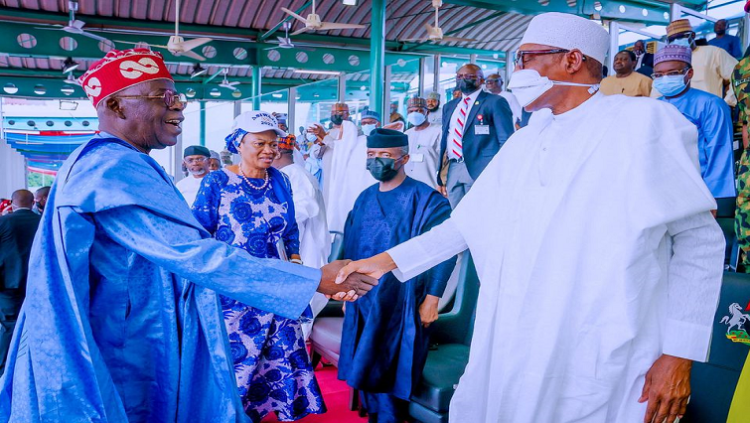 APC party's new presidential candidate Bola Tinubu shakes hands with Nigeria's President Muhammadu Buhari.