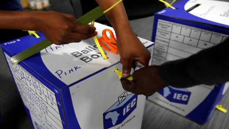 IEC officials sealing a ballot box after polling stations closed