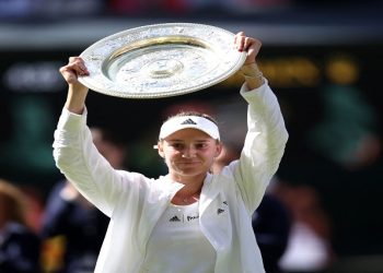 All England Lawn Tennis and Croquet Club, London, Britain - July 9, 2022 Kazakhstan's Elena Rybakina celebrates with the trophy after winning the women's singles final against Tunisia's Ons Jabeur.