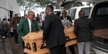 An empty coffin being carried to be displayed at Enyobeni Tavern tragedy mass funeral.